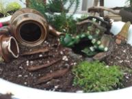 Repurposing old knick-knacks can add a quaint touch to your fairy garden.